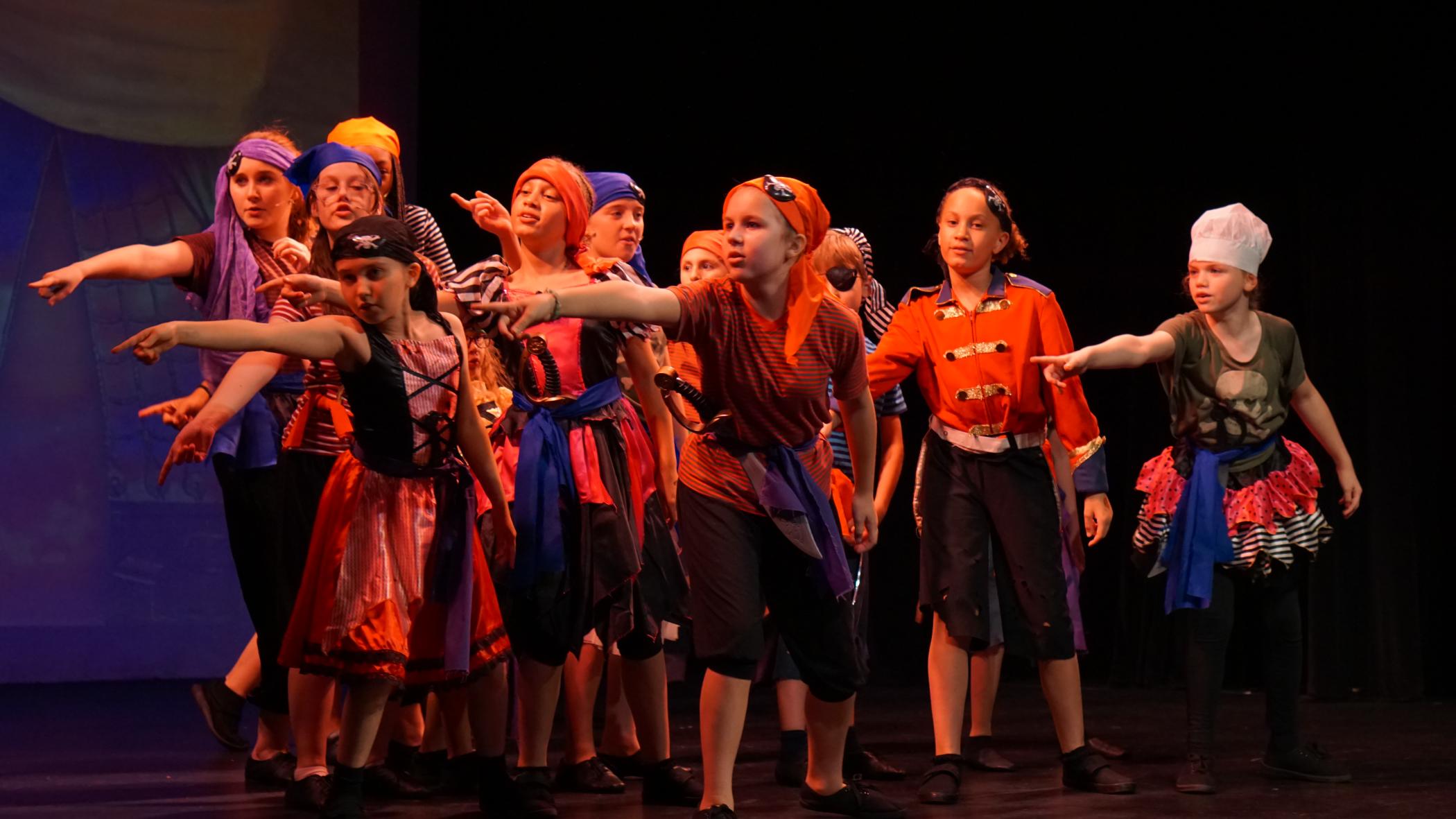 Dreams performers dancing together in a stage production