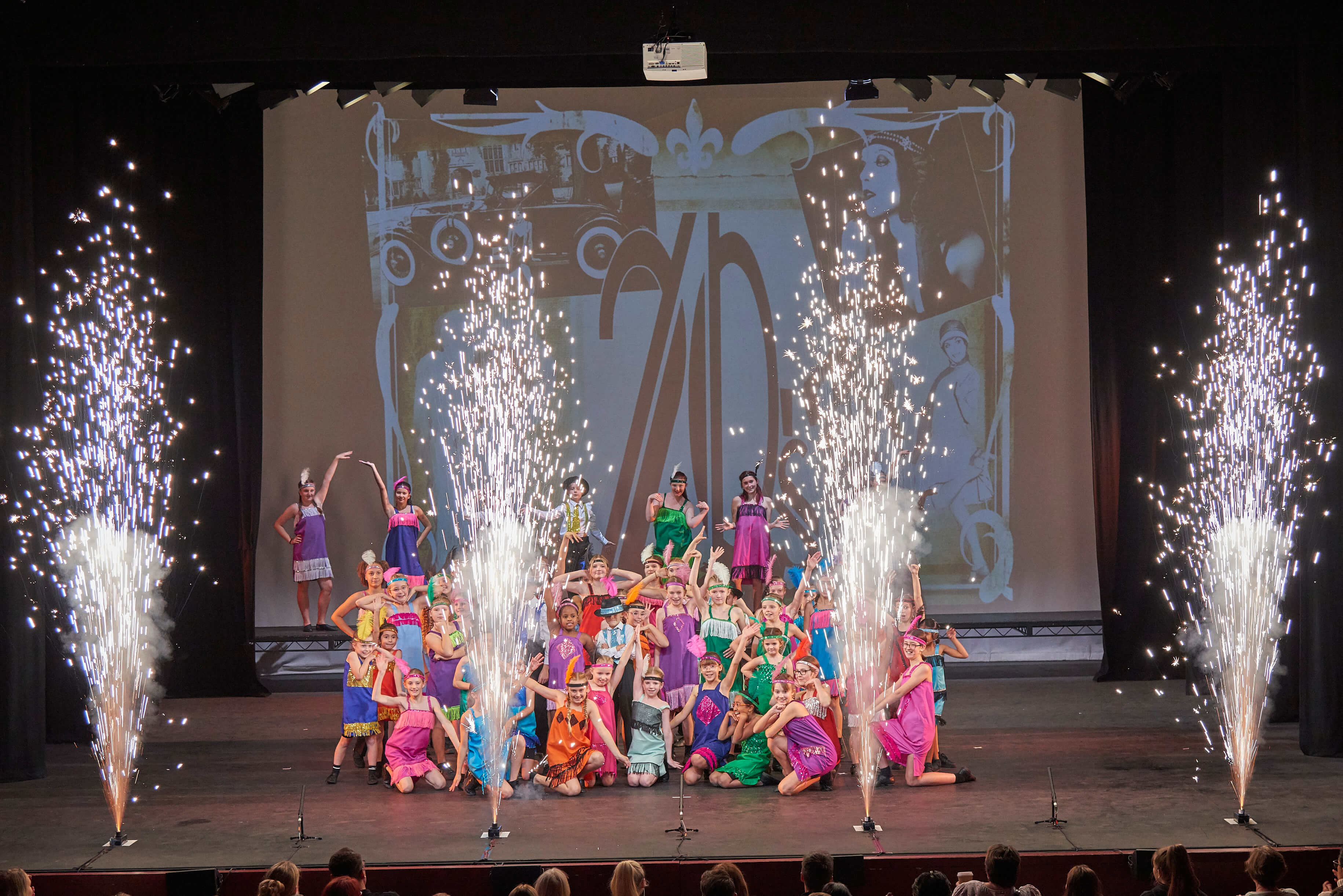 The full Dreams cast together on stage at a production finale