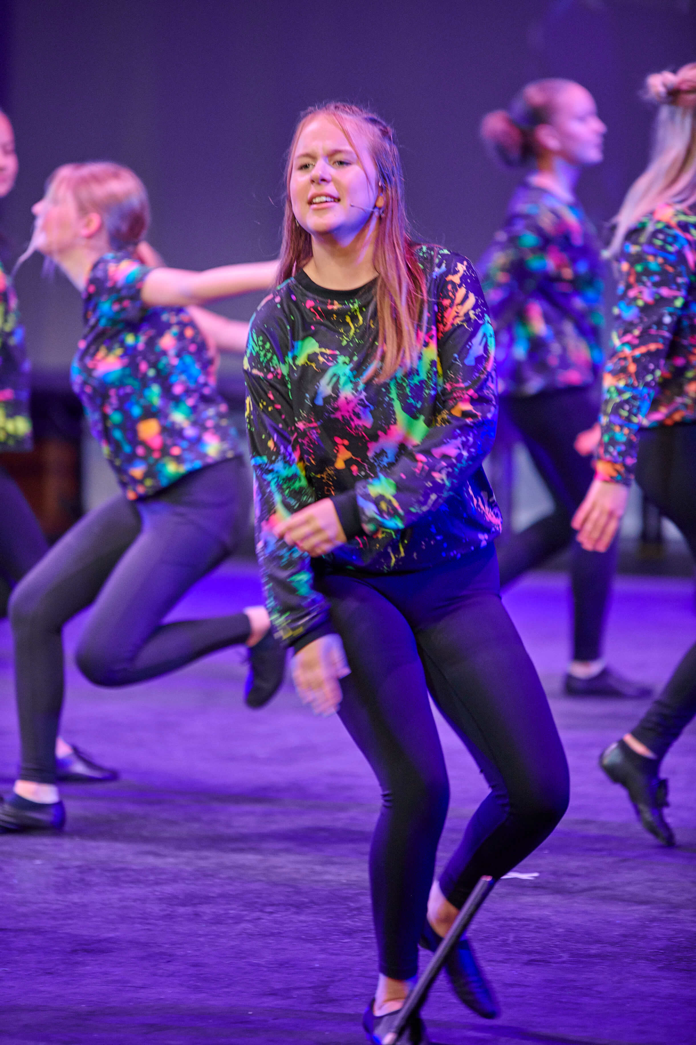 A Dreams student performing a dance routine on stage